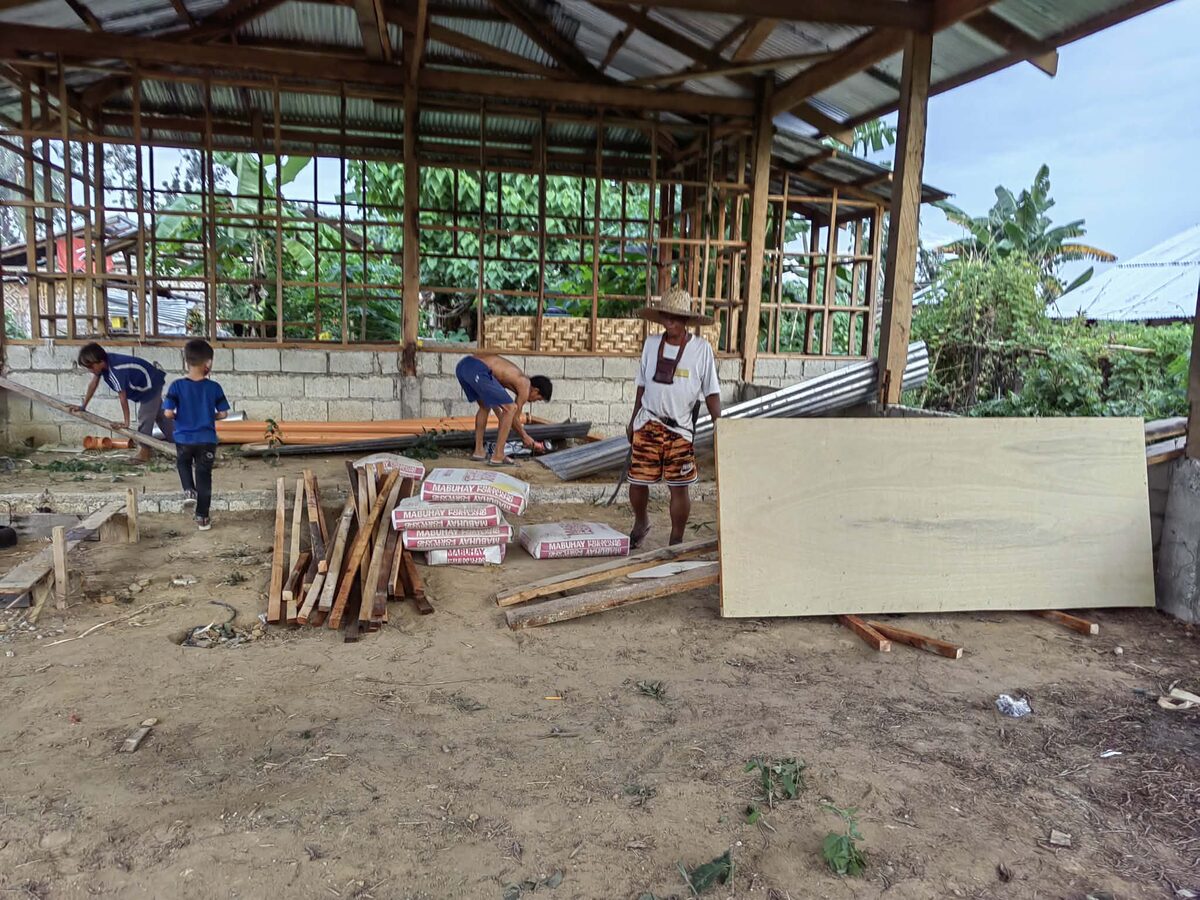 Members and children working on the church building in Inabanga