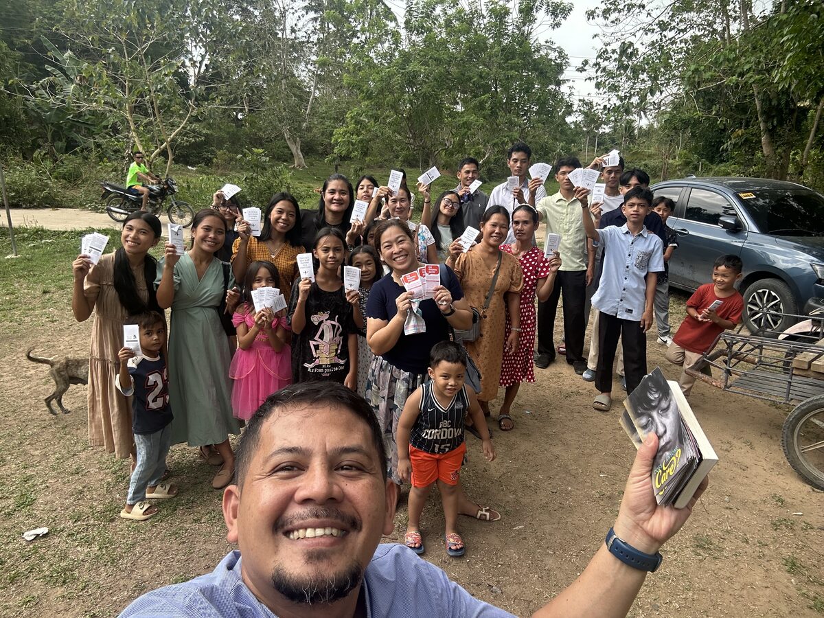 Church members holding gospel tracts before going out soulwinning